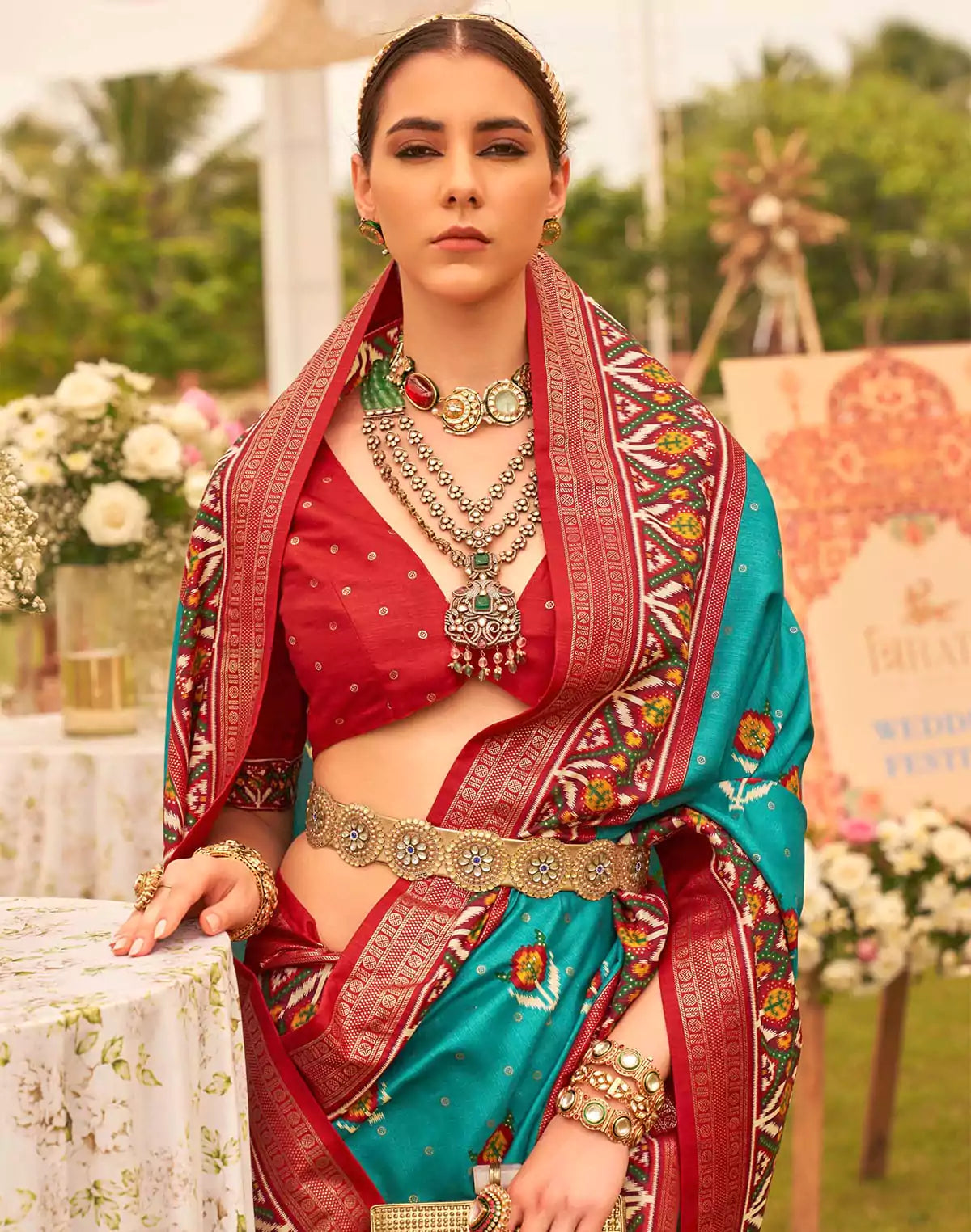 Image of Dazzling Teal Blue Patola Print Trendy Saree